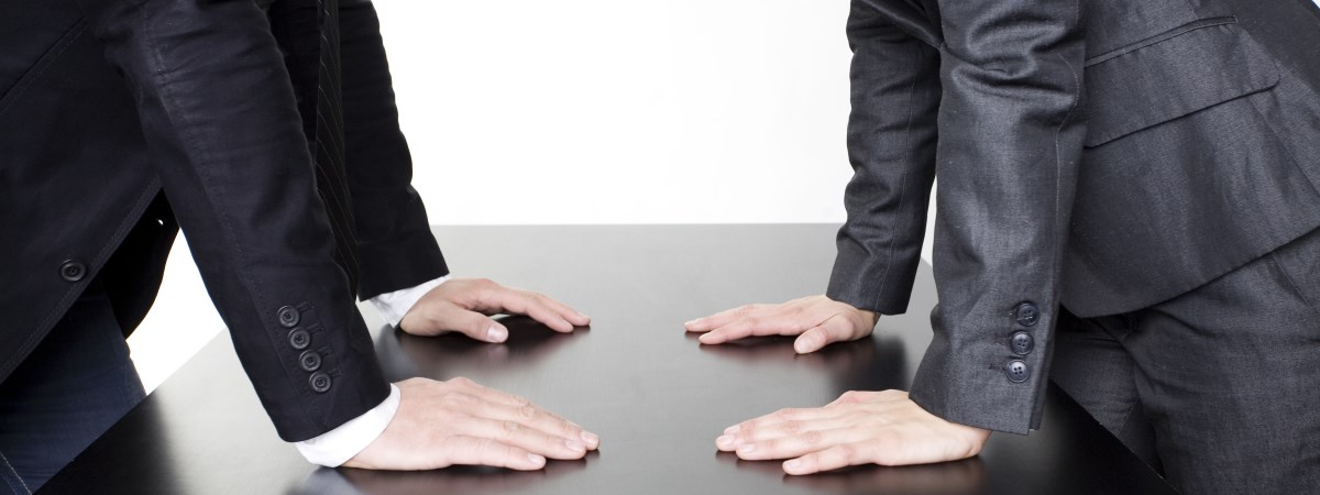 In inheritance disputes two men are facing each other - supporting their hands on the table between them. That is symbolic for inheritance disputes between coheirs.